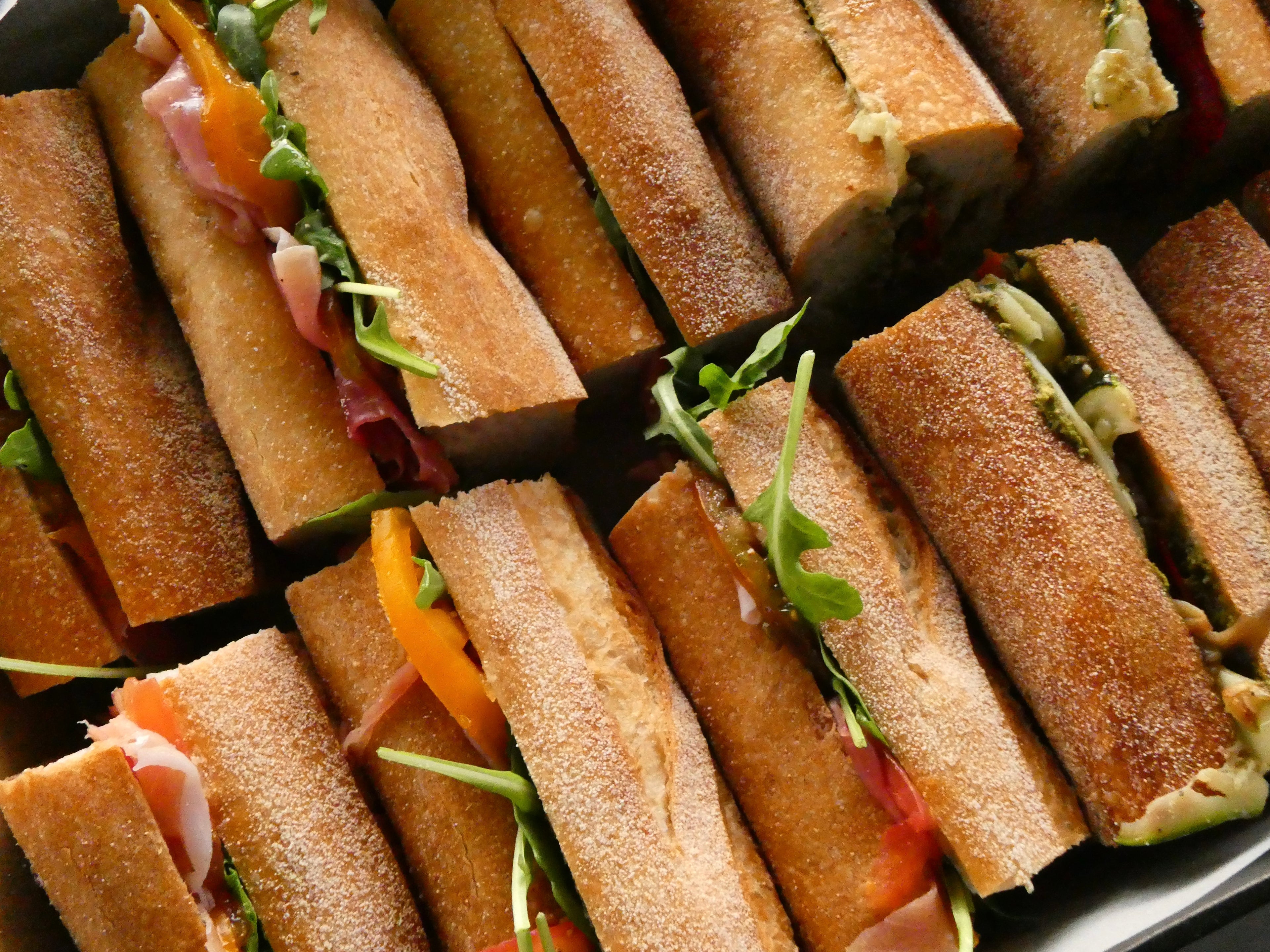 Close-up of gourmet baguettes in a catering box.